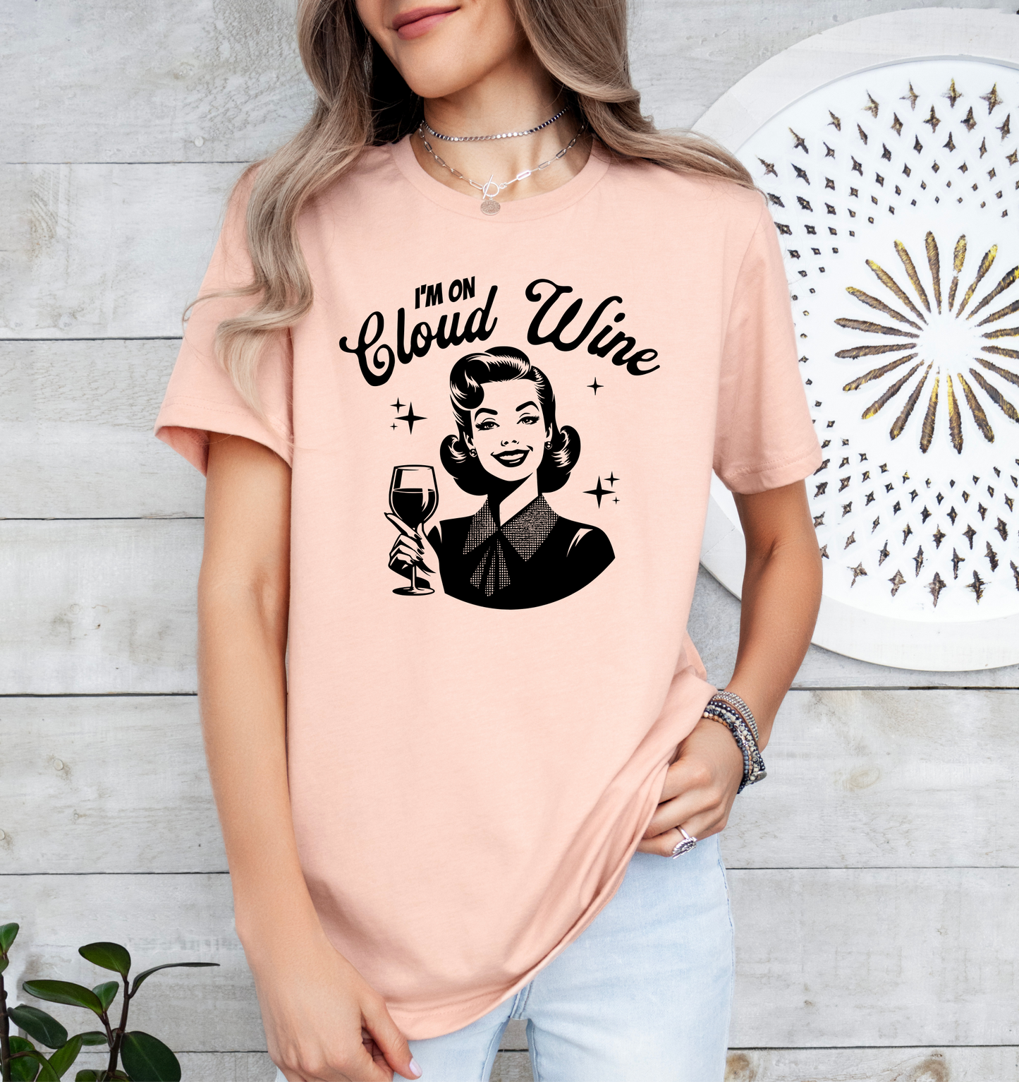 a woman wearing a pink shirt that says i'm on cloud wine
