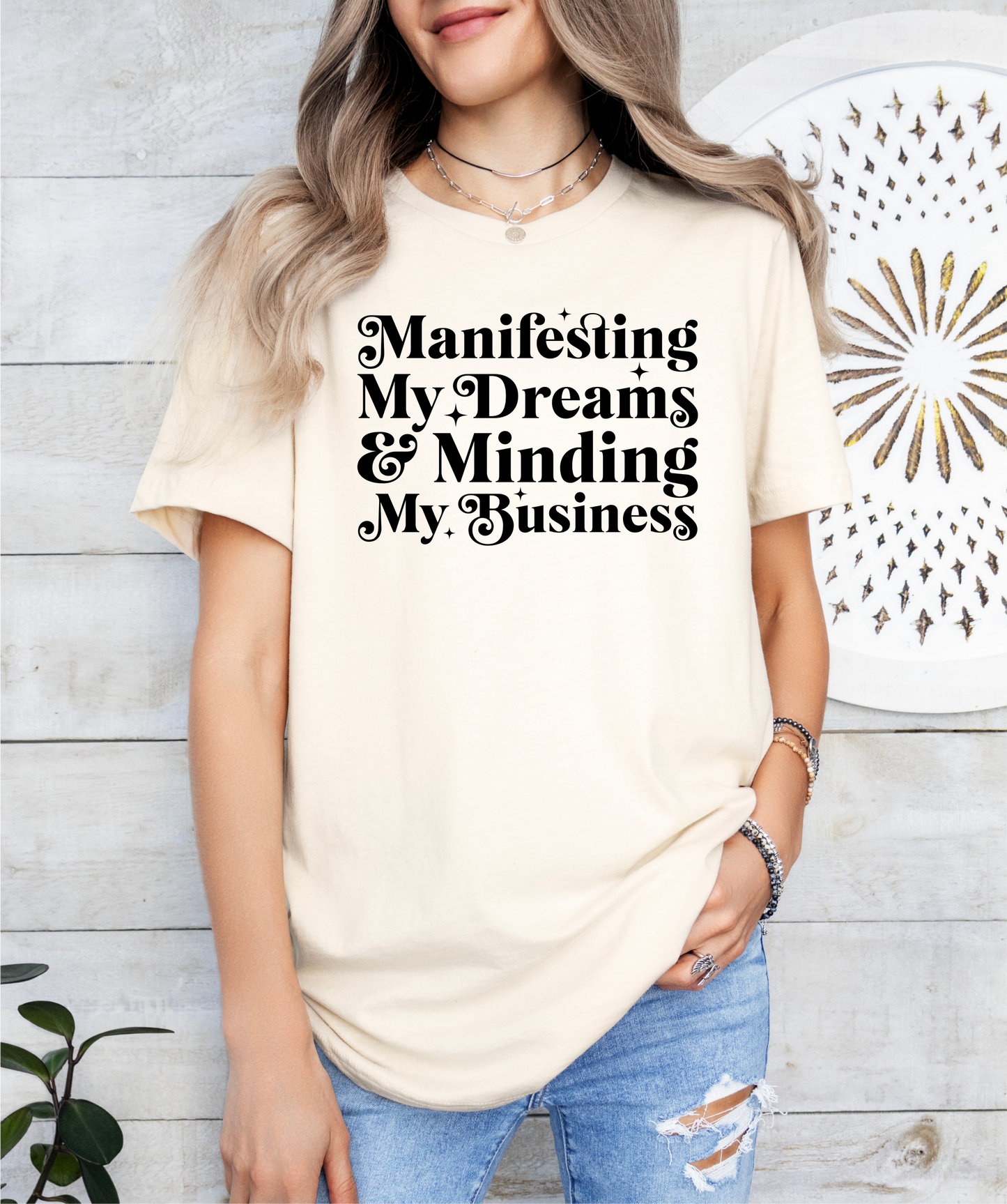 a woman wearing a t - shirt that says, manifising my dreams and
