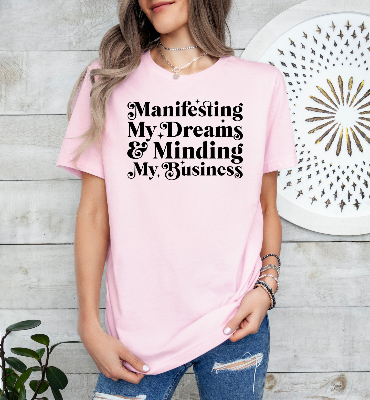 a woman wearing a pink t - shirt with black writing on it