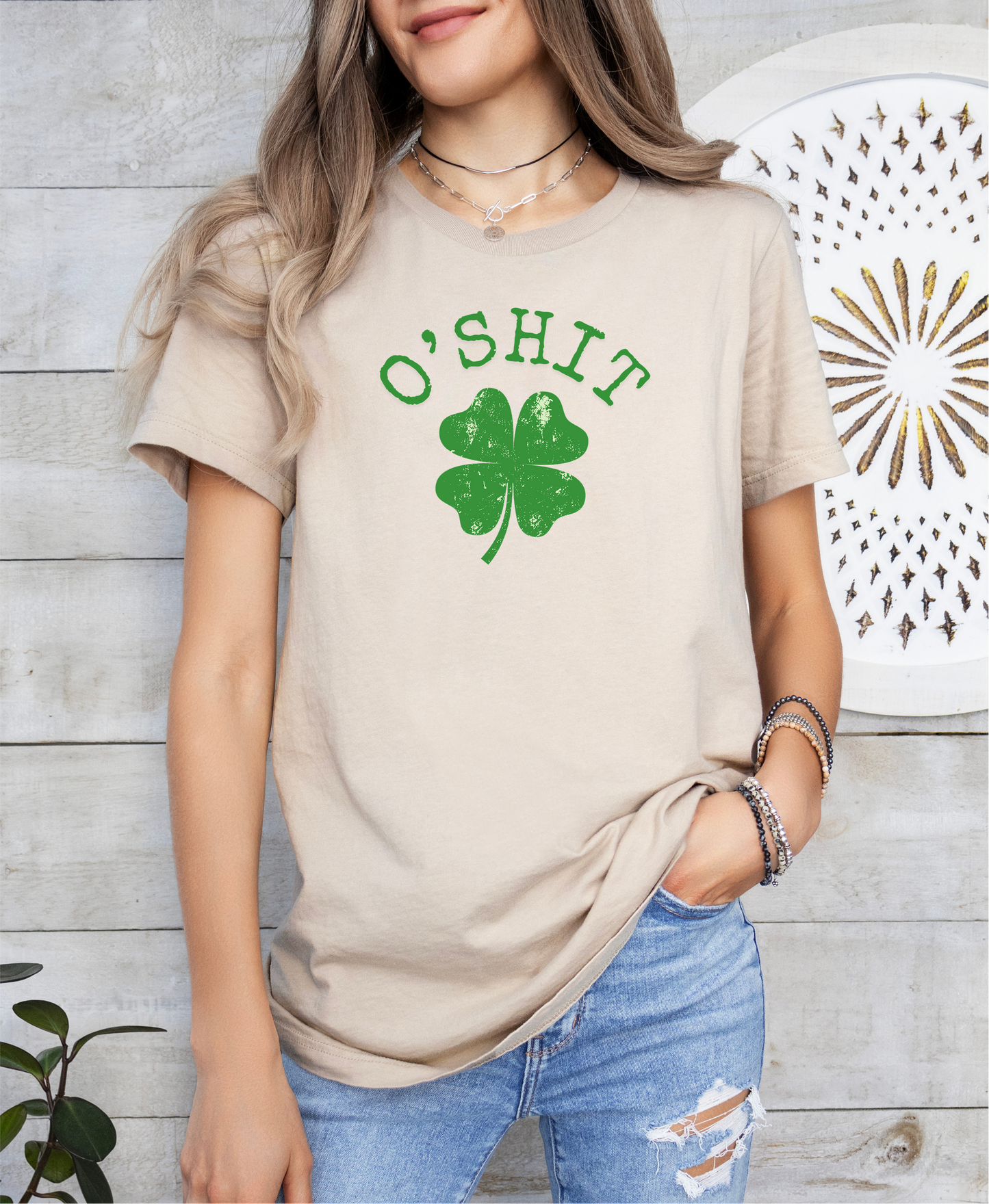 a woman wearing a t - shirt with a shamrock on it