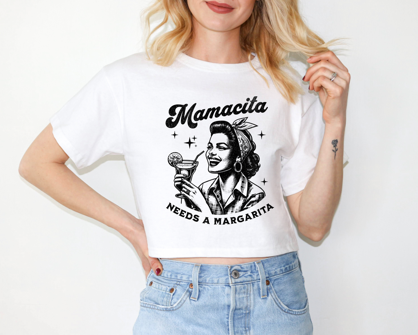 a woman wearing a white t - shirt with a picture of a woman holding a