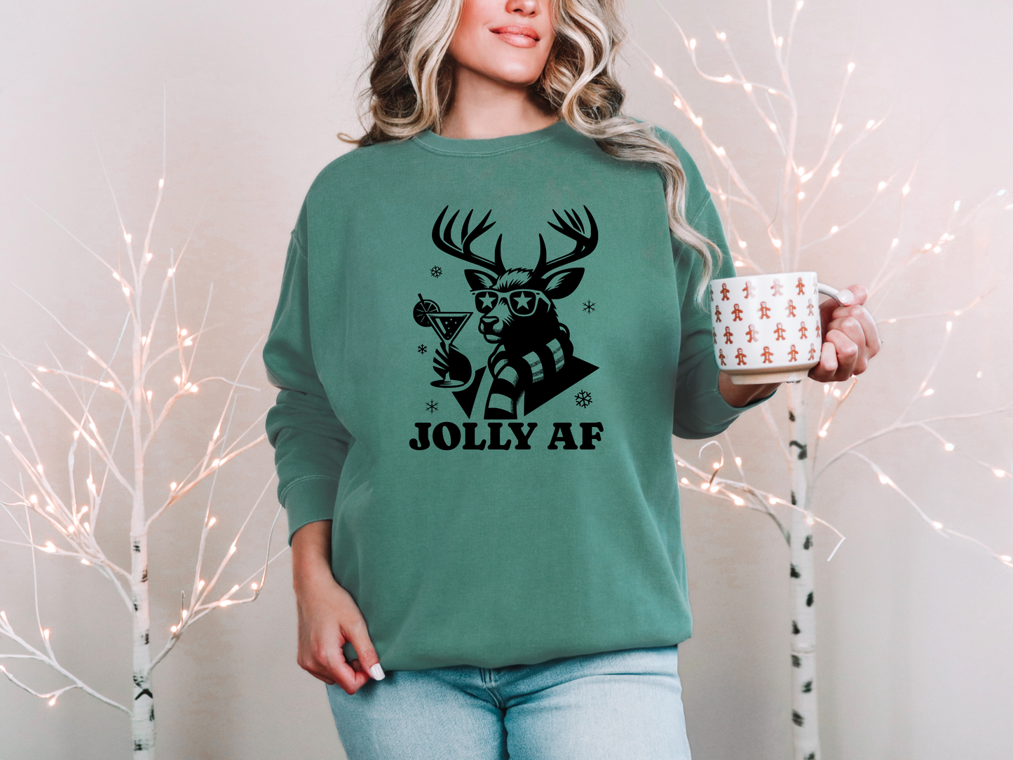 a woman in a green sweatshirt holding a coffee mug