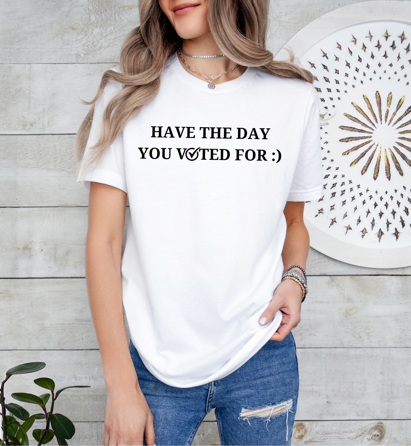 a woman wearing a white t - shirt that says have the day you waited for