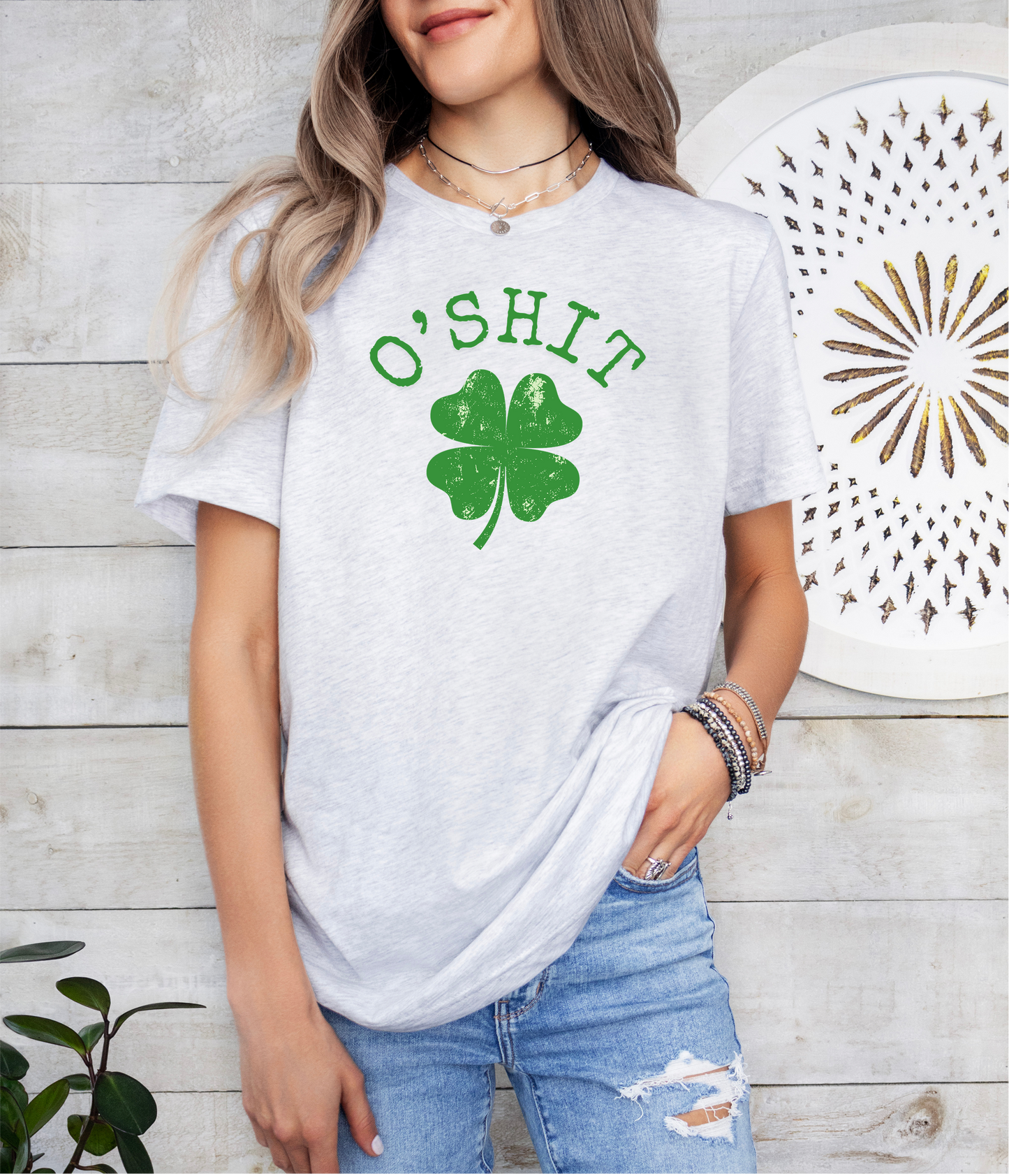 a woman wearing a white shirt with a shamrock on it