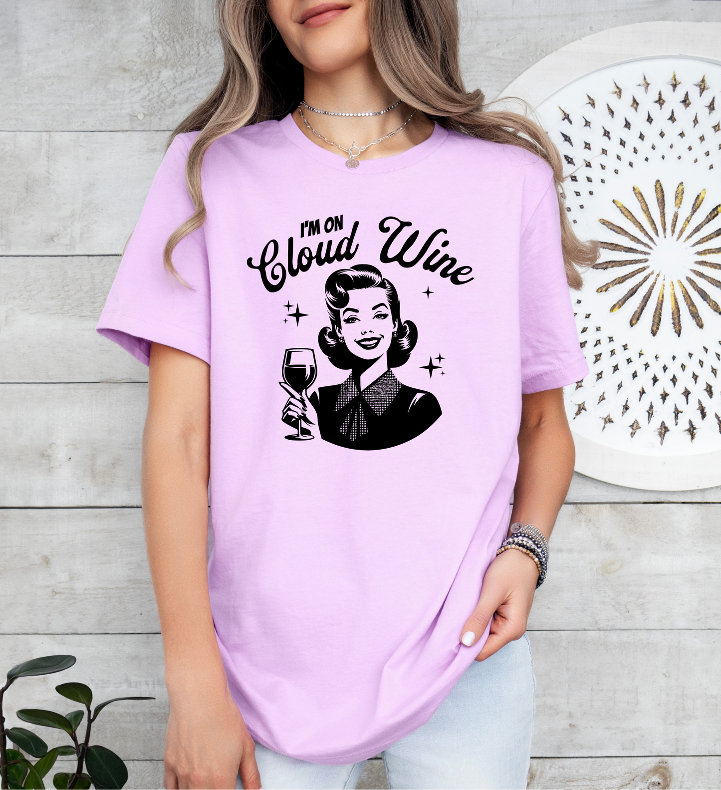 a woman in a pink shirt holding a glass of wine