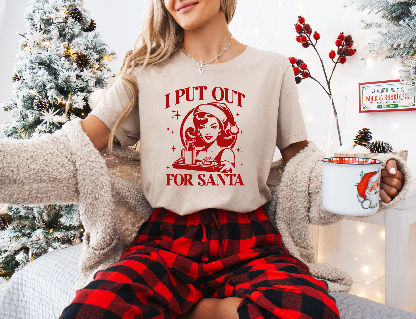 a woman wearing a t - shirt that says i put out for santa