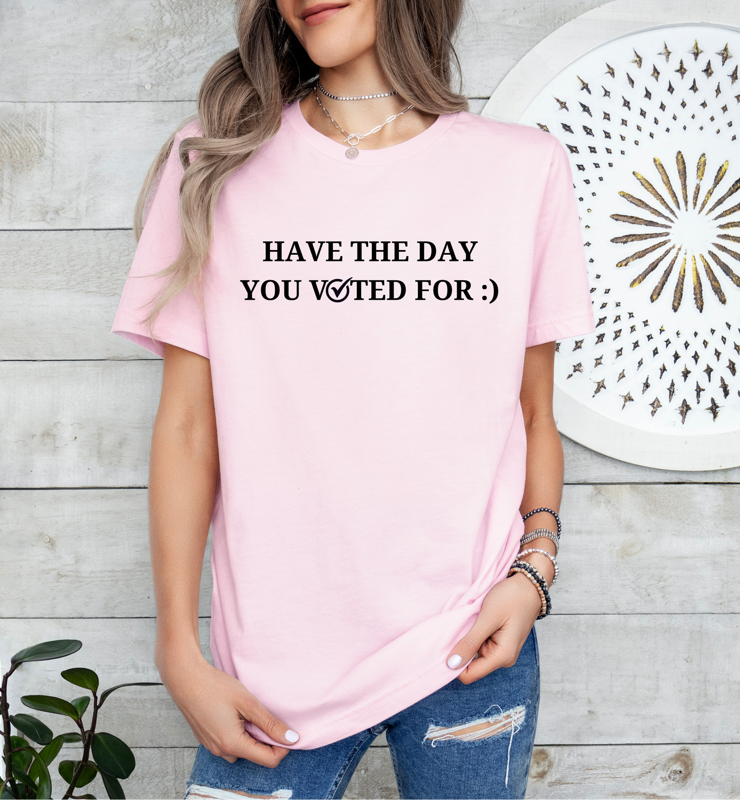 a woman wearing a pink t - shirt that says have the day you waited for