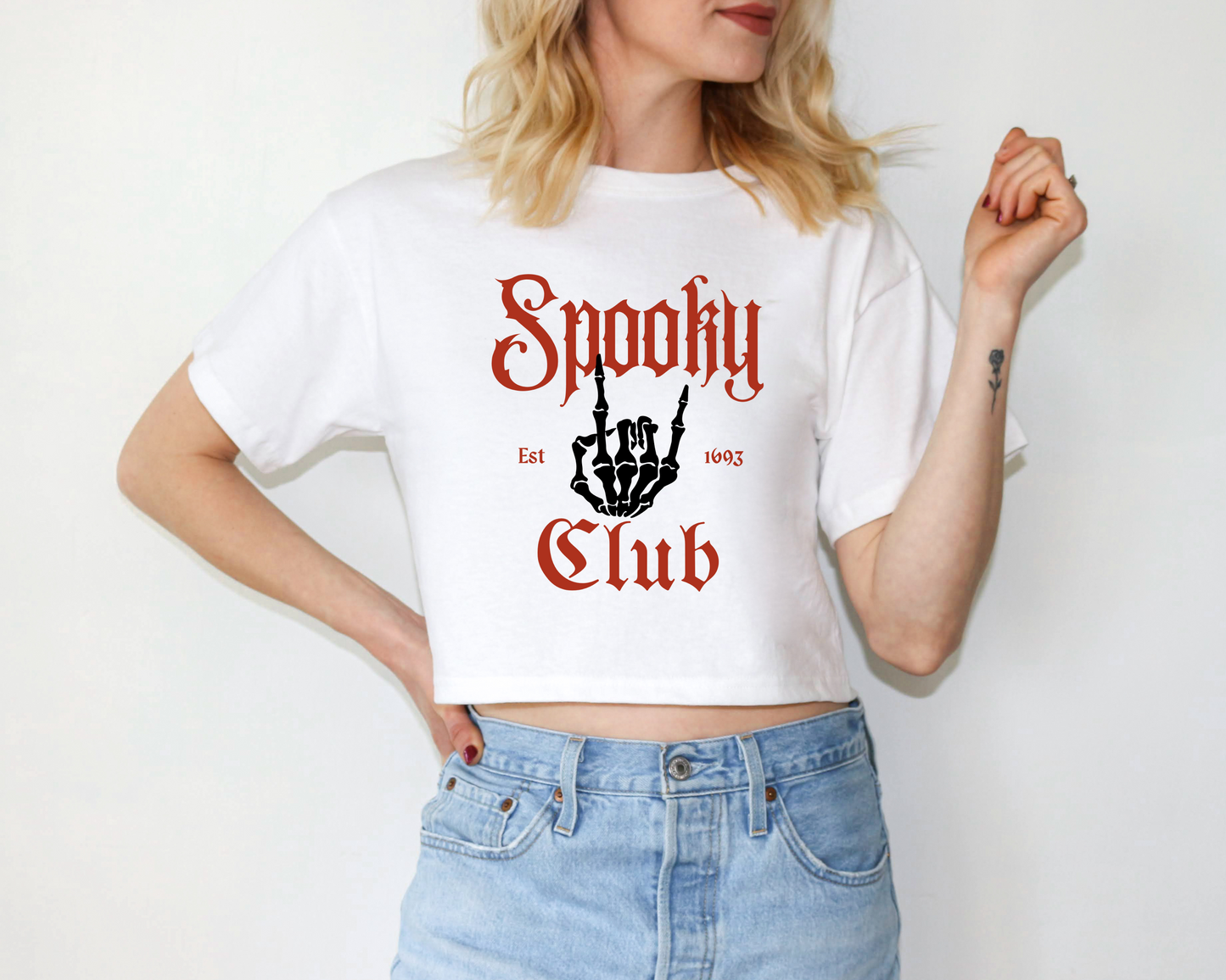a woman wearing a shirt that says spooky club