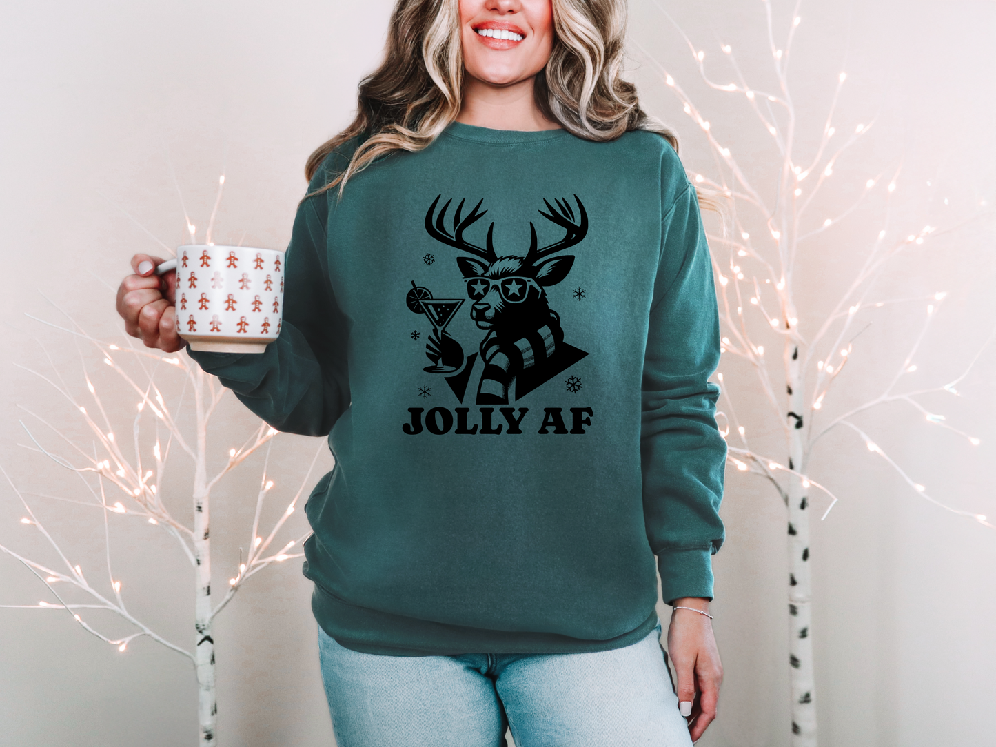 a woman in a green sweatshirt holding a coffee mug