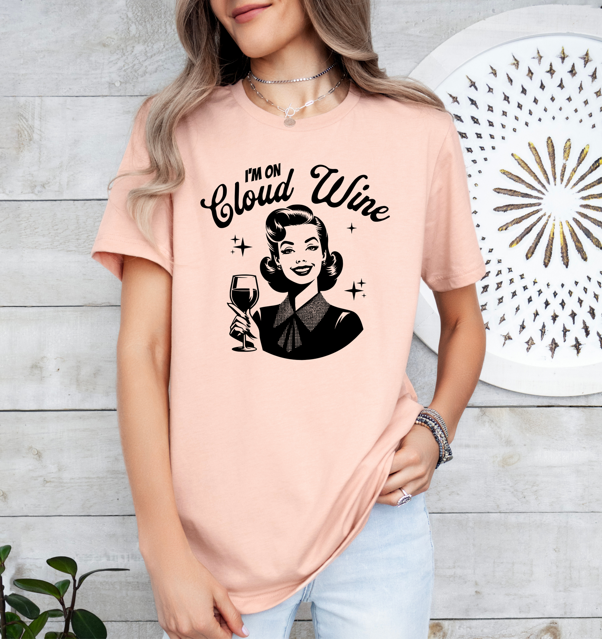 a woman wearing a pink shirt that says i'm on cloud wine