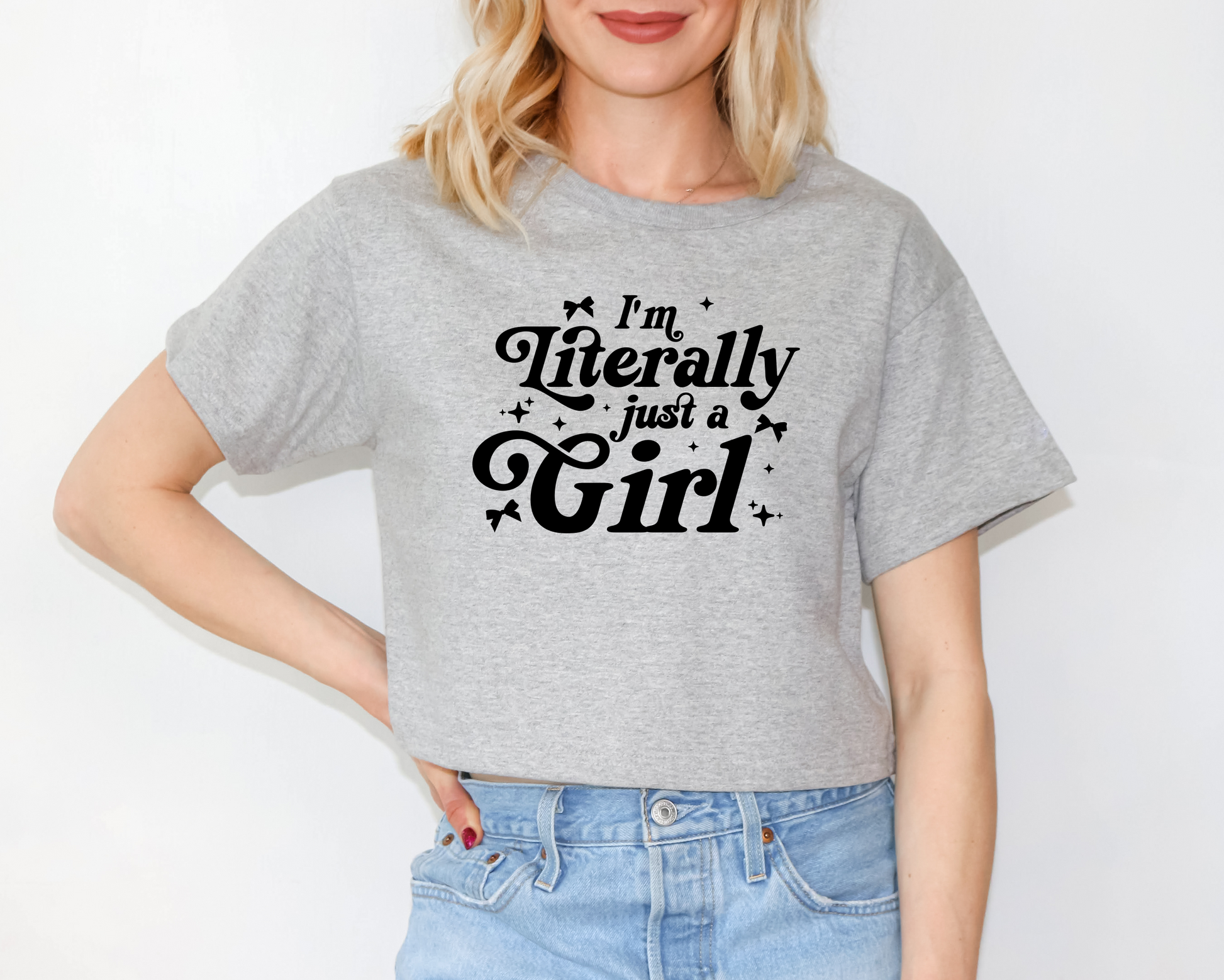 a woman wearing a grey t - shirt that says i'm literally just a