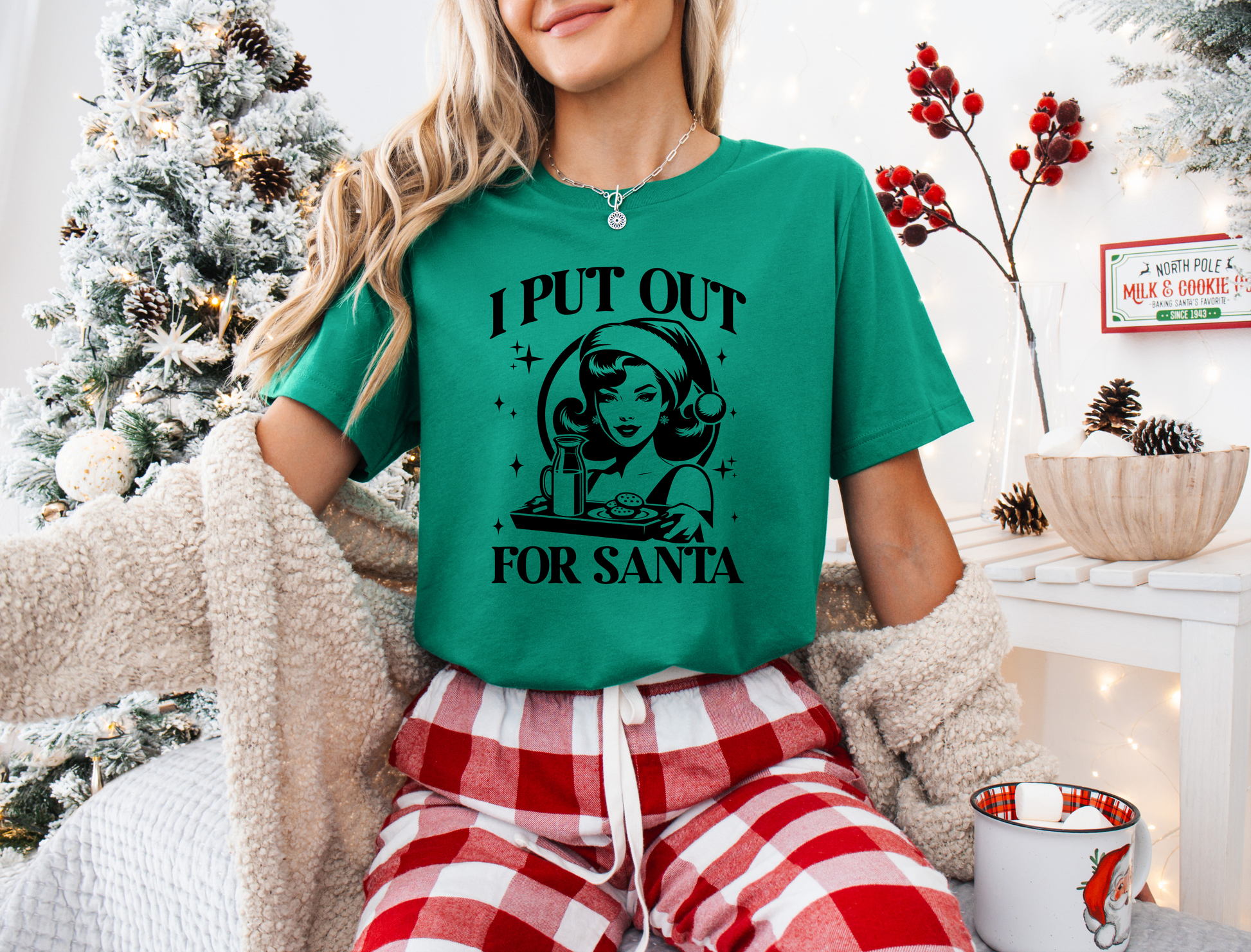 a woman wearing a green t - shirt that says i put out for santa