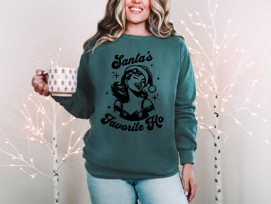 a woman in a green sweater holding a coffee mug