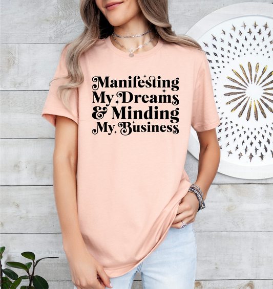 a woman wearing a pink t - shirt with black writing on it