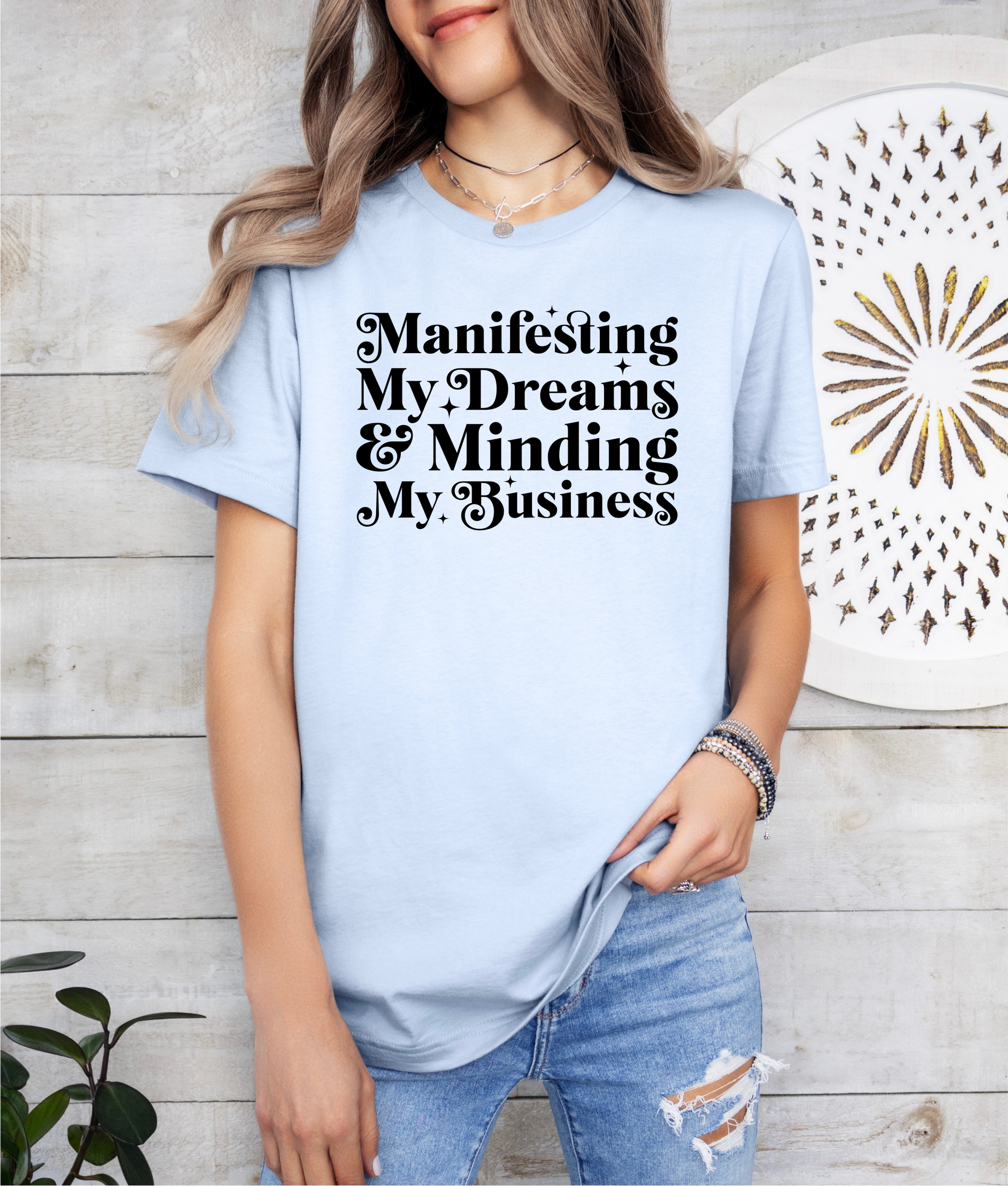 a woman wearing a t - shirt that says manifising my dreams and mind