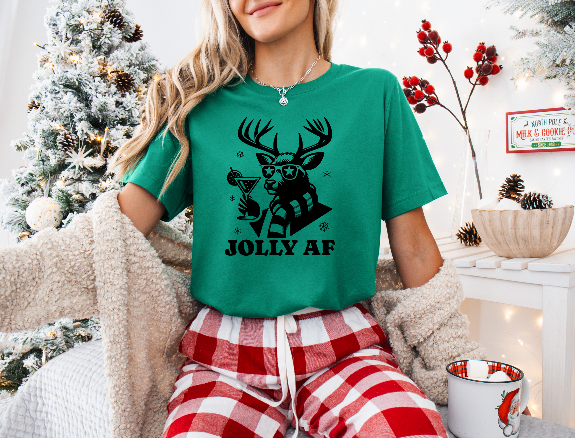 a woman wearing a green t - shirt with a deer on it